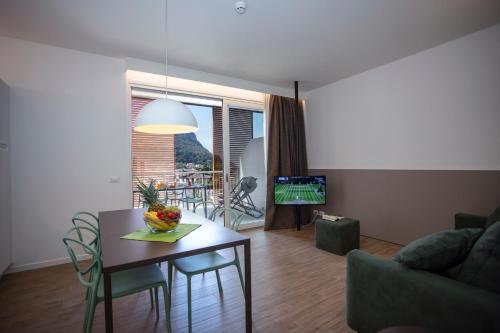 a living room with a table and a couch at Residenza Olivo in Garda