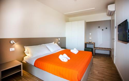a hotel room with a bed with towels on it at Residenza Olivo in Garda