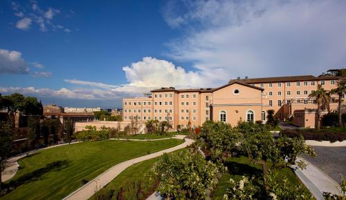 a large building with a park in front of it at Villa Agrippina Gran Meliá – The Leading Hotels of the World in Rome