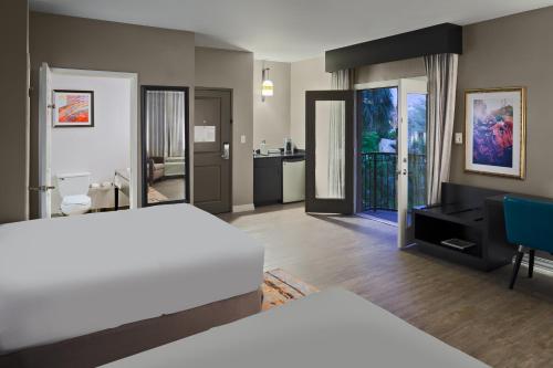 a hotel room with a bed and a bathroom at Hotel Indigo San Antonio Riverwalk by IHG in San Antonio
