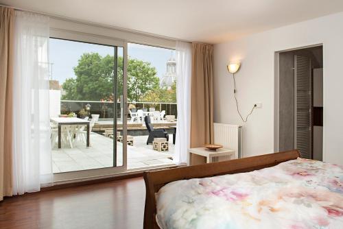 a bedroom with a bed and a view of a patio at Sol Aureus in Middelburg