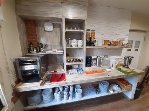 a kitchen with a counter with dishes on it at Pensión O Escondidino in Baiona