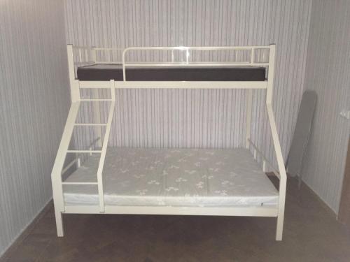białe łóżko piętrowe w narożnej części pokoju w obiekcie Квартира на Фонтане. w Odessie