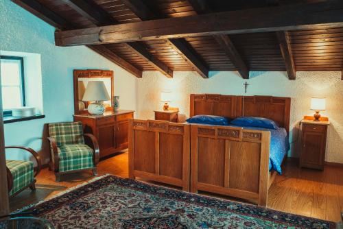a bedroom with a bed and a chair and a mirror at Az. Agr. Tenuta La Casetta in Mama
