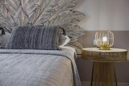 a bedroom with a bed and a lamp on a table at Makis Hotel in Skala Kefalonias