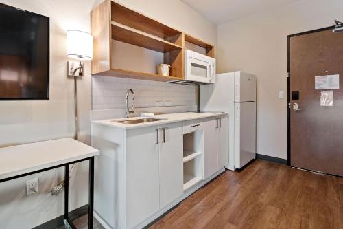 a small kitchen with a sink and a refrigerator at Extended Stay America Premier Suites - Port Charlotte - I-75 in Port Charlotte