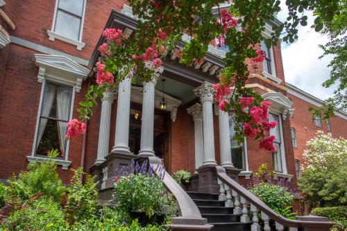 a red brick house with flowers on the stairs at Kehoe House, Historic Inns of Savannah Collection in Savannah