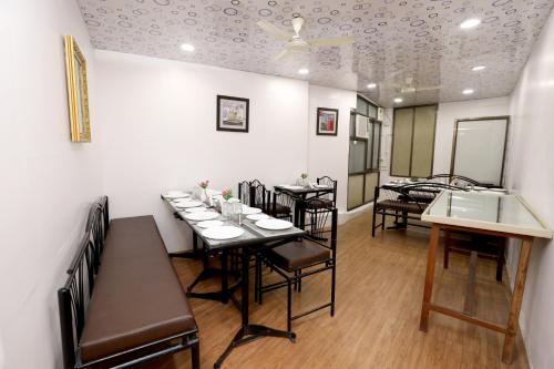 a dining room with tables and chairs and a ceiling at The Leef Inn 500ms from Nakki Lake in Mount Ābu