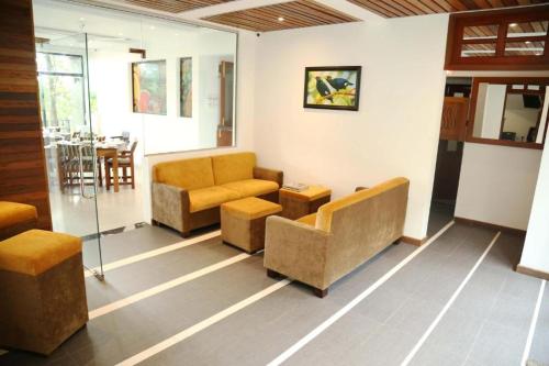 a living room with two couches and a table at Spring Villas Kandy in Kandy