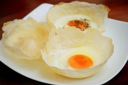 two eggs on a plate on a white plate at Spring Villas Kandy in Kandy