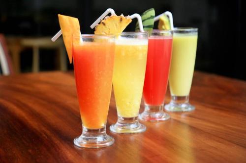 a group of four different types of drinks on a table at Spring Villas Kandy in Kandy
