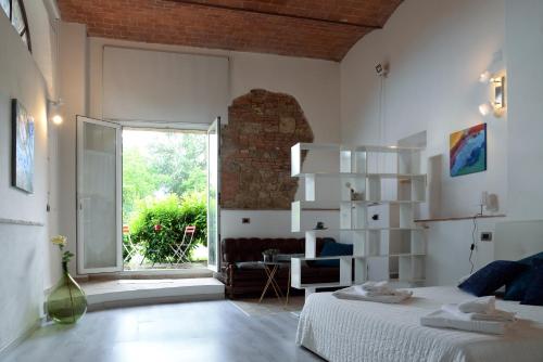 a bedroom with a bed and a large window at L'Albero Di Gamelì in Chiusi