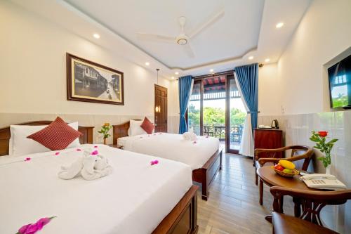 Postel nebo postele na pokoji v ubytování Bonsai Villa Hoi An