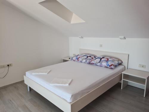 Postel nebo postele na pokoji v ubytování Apartmani Magaš