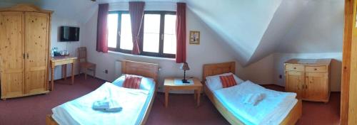 a small room with two beds and a window at Radegastova chalupa in Frýdek-Místek