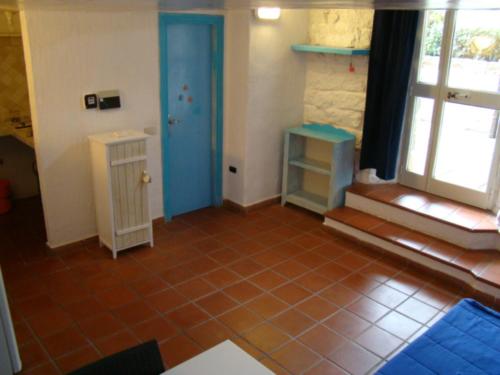 een kamer met een blauwe deur en een tegelvloer bij Palau Flat in Palau