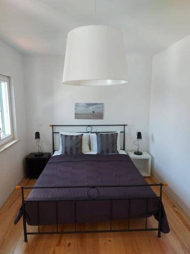 a bedroom with a bed with a purple bedspread at Apartments Coral of Dubrovnik in Dubrovnik