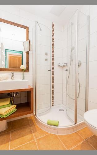a bathroom with a shower and a sink at Steigmühle Pension Garni in Füssen