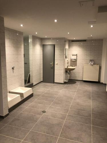 a large bathroom with a toilet and a sink at Hotel Fürsteneck in Bernburg