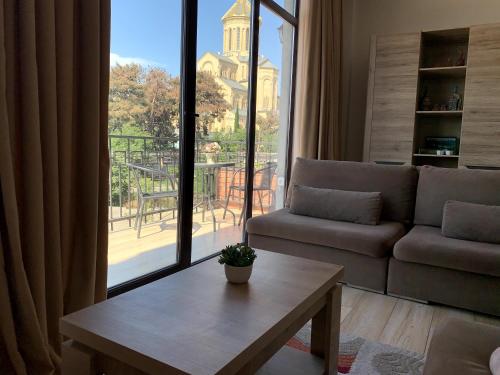 a living room with a couch and a table at SaBa Apartments in Old Tbilisi in Tbilisi City