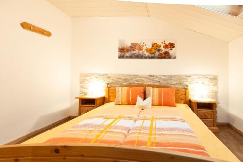 a bedroom with a large bed with orange pillows at Haus Schöpf in Neustift im Stubaital