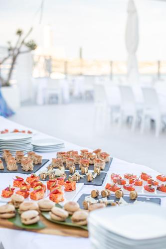 a table with many different types of donuts and plates at Hotel Approdo di Venere in Vieste