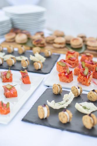 a table with several trays of food on it at Hotel Approdo di Venere in Vieste