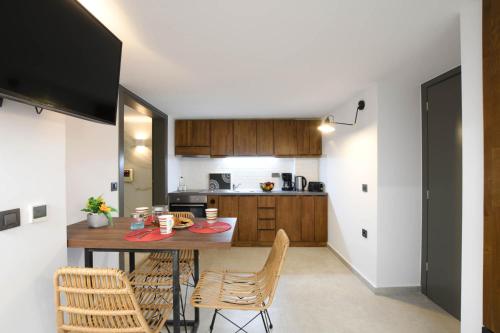 a kitchen with a table and chairs in a room at Orion Eco Suites in Karteros