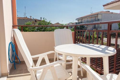 a white table and chairs on a balcony at JJ Rooms luxury apartments in Kallithea Halkidikis