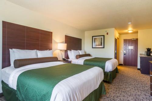a hotel room with two beds in a room at Cobblestone Hotel & Suites - Erie in Erie