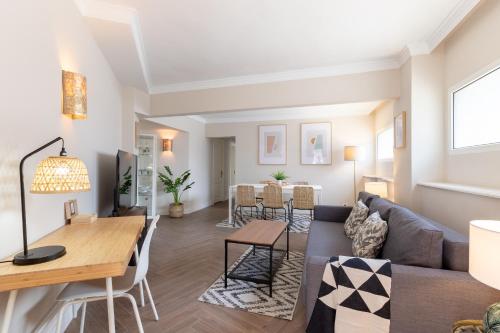 a living room with a couch and a table at Apt in Neguri, 5 min from the beach & metro in Getxo