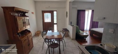 a kitchen with a table and chairs in a room at Apartments Mamic in Pula
