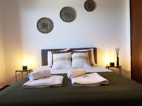 a bedroom with a bed with two towels on it at WOW OCEAN VIEW, 150mts to Beach & 10 min to Centre in Lagos