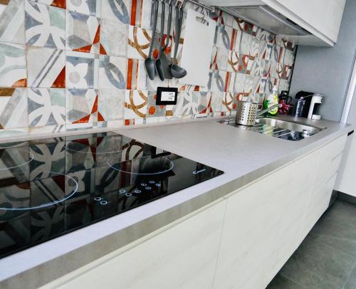a kitchen with a counter with a stove top oven at "Sweet Life" Casa Vacanze in Lipari