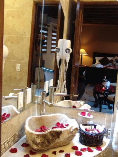 a bathroom counter with two sinks and a mirror at Casa del Tio Hotel Boutique in San Miguel de Allende