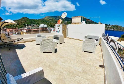 a patio with chairs and tables on a roof at "Sweet Life" Casa Vacanze in Lipari