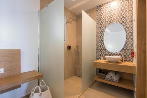 a bathroom with a sink and a mirror at Two Goats Villas in Kyra Panagia