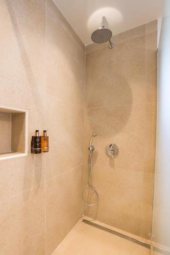 a shower with a shower head in a bathroom at Two Goats Villas in Kyra Panagia
