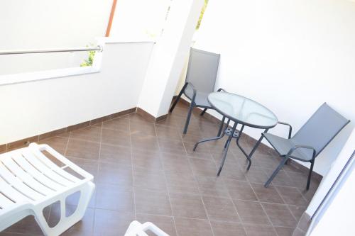 a room with chairs and a table and a window at Apartments Milas in Trogir