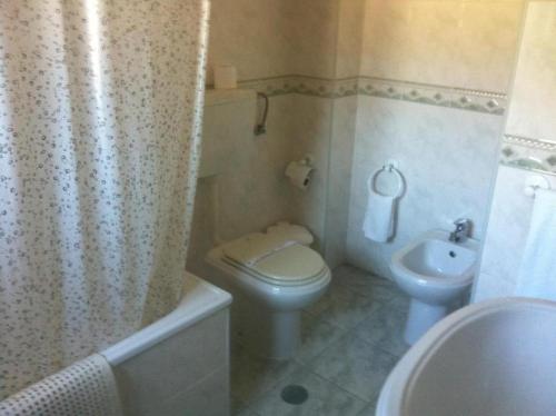 a bathroom with a toilet and a sink at A Moderna - CALDAS DA FELGUEIRA in Caldas da Felgueira