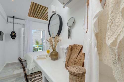 a white room with a dressing table and mirror at Anatoli Hotel in Naxos Chora
