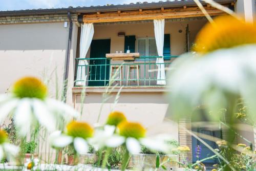 a house with a balcony with a table and chairs at Fonte Flavia in Urbania