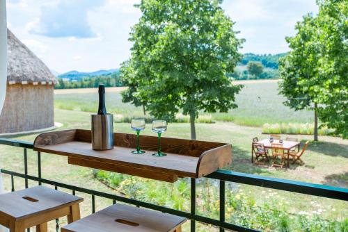 a table with two glasses of wine on a balcony at Fonte Flavia in Urbania