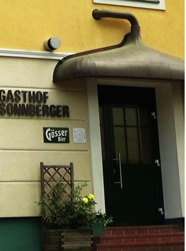 a house with a sign on the side of it at Landgasthof Sonnberger in Klein Sankt Paul