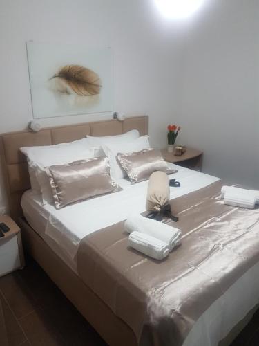 a large white bed with two pillows on it at Apartment FUNNY in Kotor