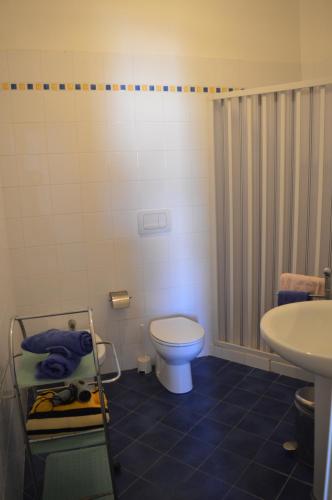 a bathroom with a toilet and a sink at Casa Blue in Favignana