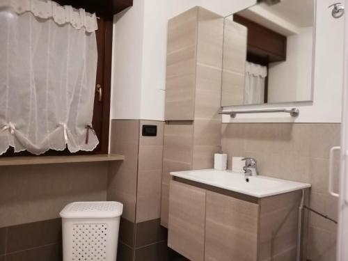 a bathroom with a sink and a toilet at Appartamento Le Moulin in Aosta