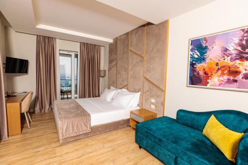 a hotel room with a bed and a couch at Sea View Hotel in Himare