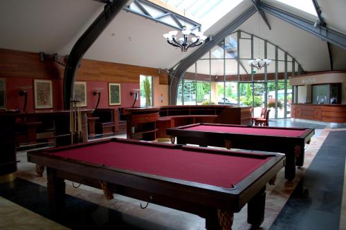 a billiard room with two pool tables in it at 4 Pory Roku Resort Sauna & Spa in Bąkowo
