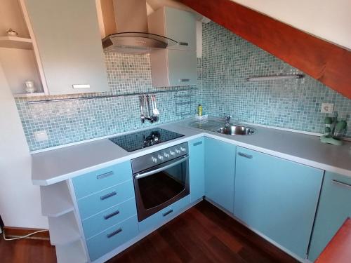 a kitchen with blue cabinets and a sink at Villa Sv. Petar in Trogir